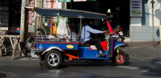 Polished TukTuk riding through the streets of Bangkok